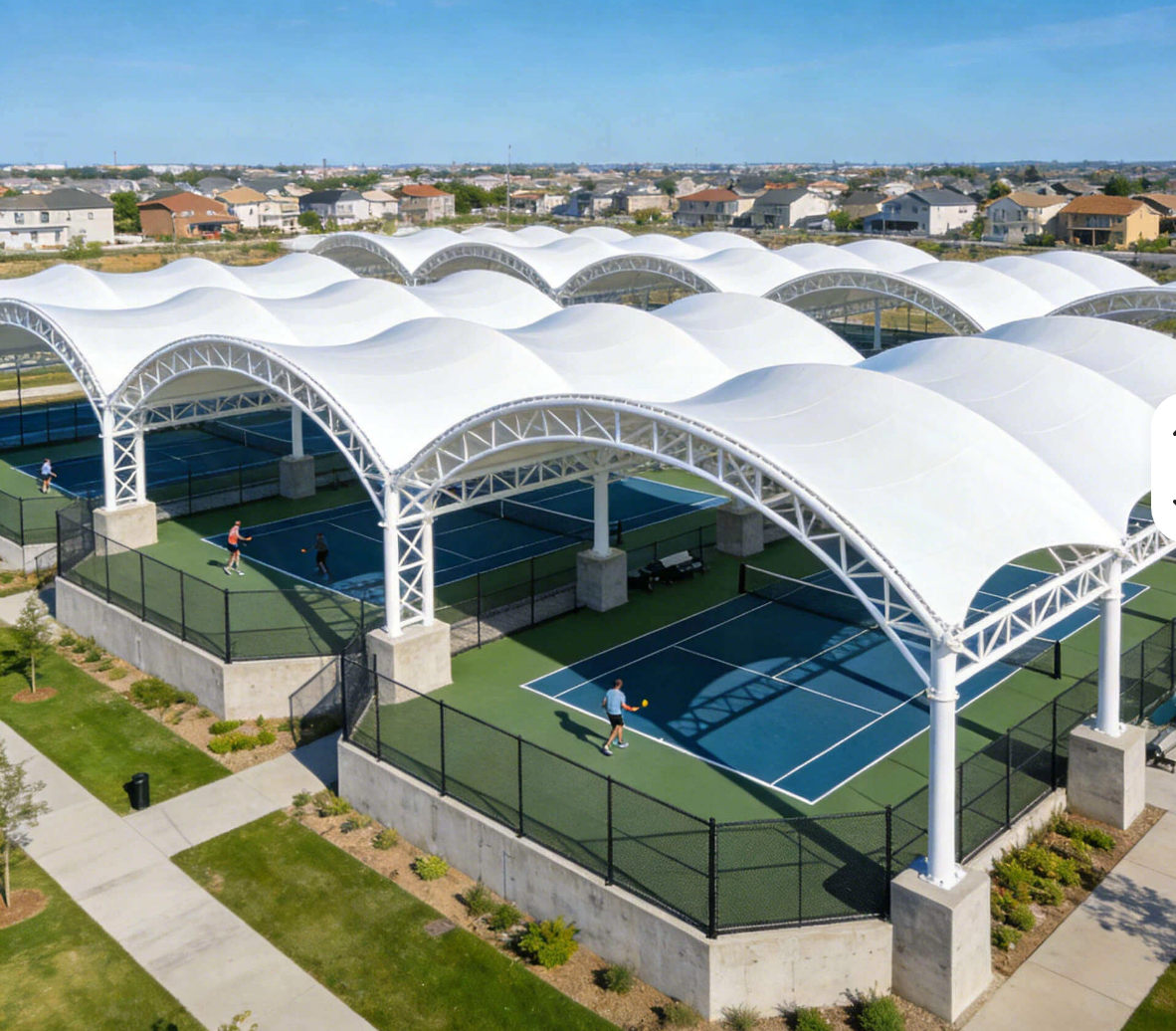 Multi-court tennis complex under white tensile membrane roofs